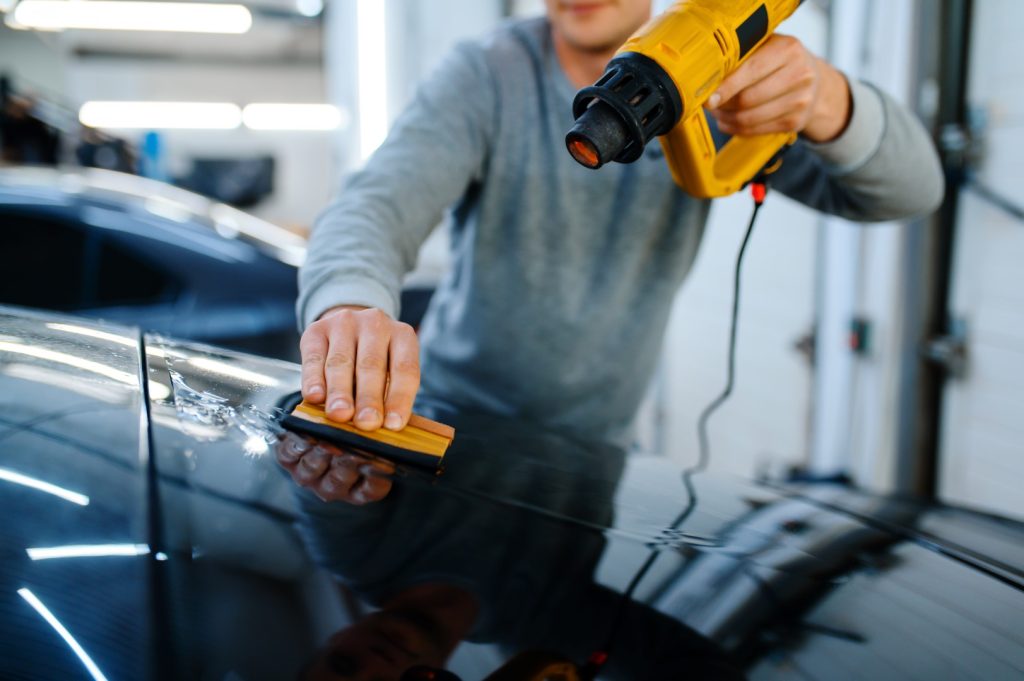 Car window tinting professional heating tinted film for smooth finish.
